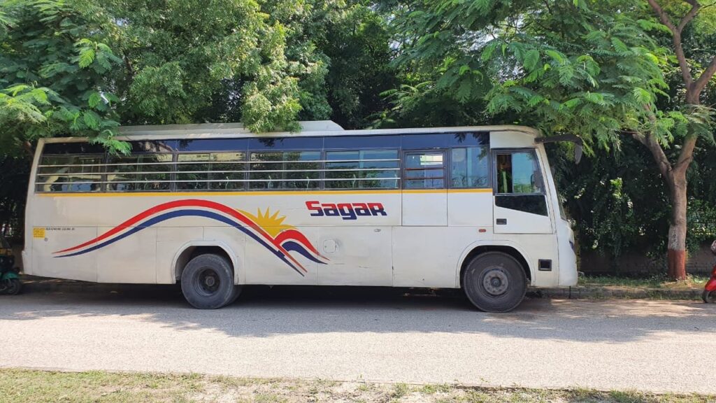 A Bus with Sagar Travels branding, available for rent for transportation, displayed by Travel Art.